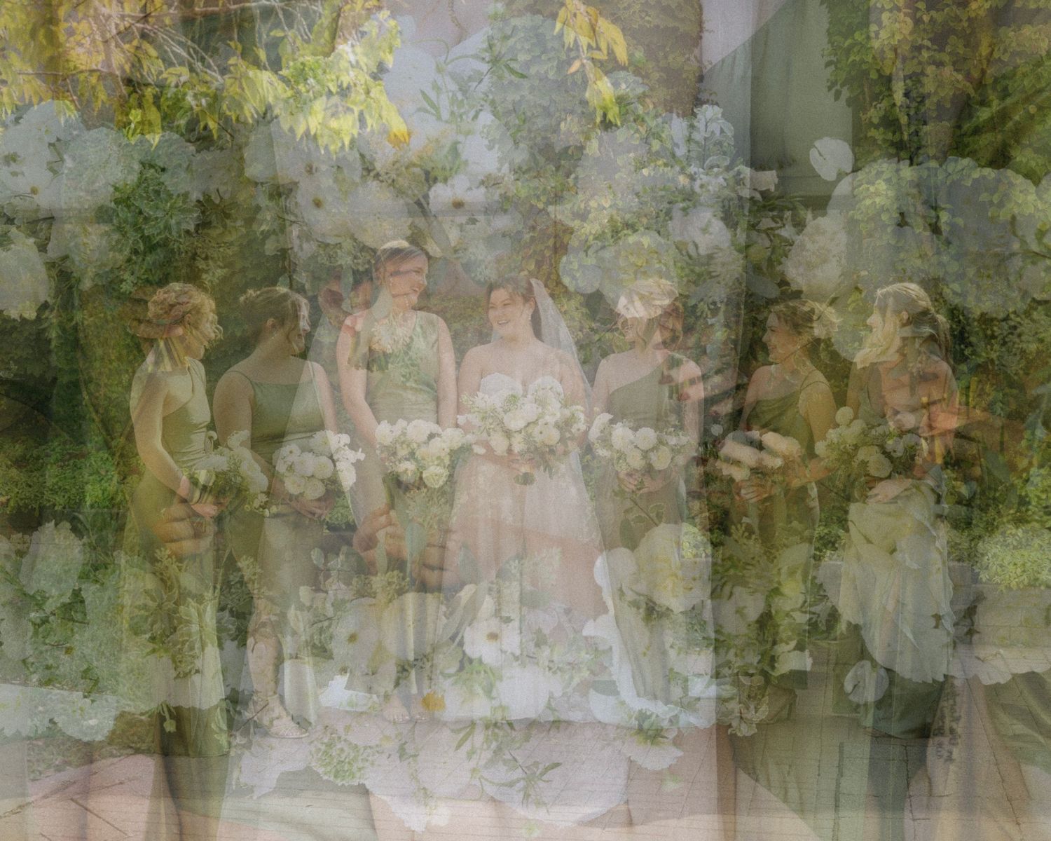 A bride wearing a lace veil smiles and laughs looking at her bridesmaids is accompanies by an overlay of green and white florals.