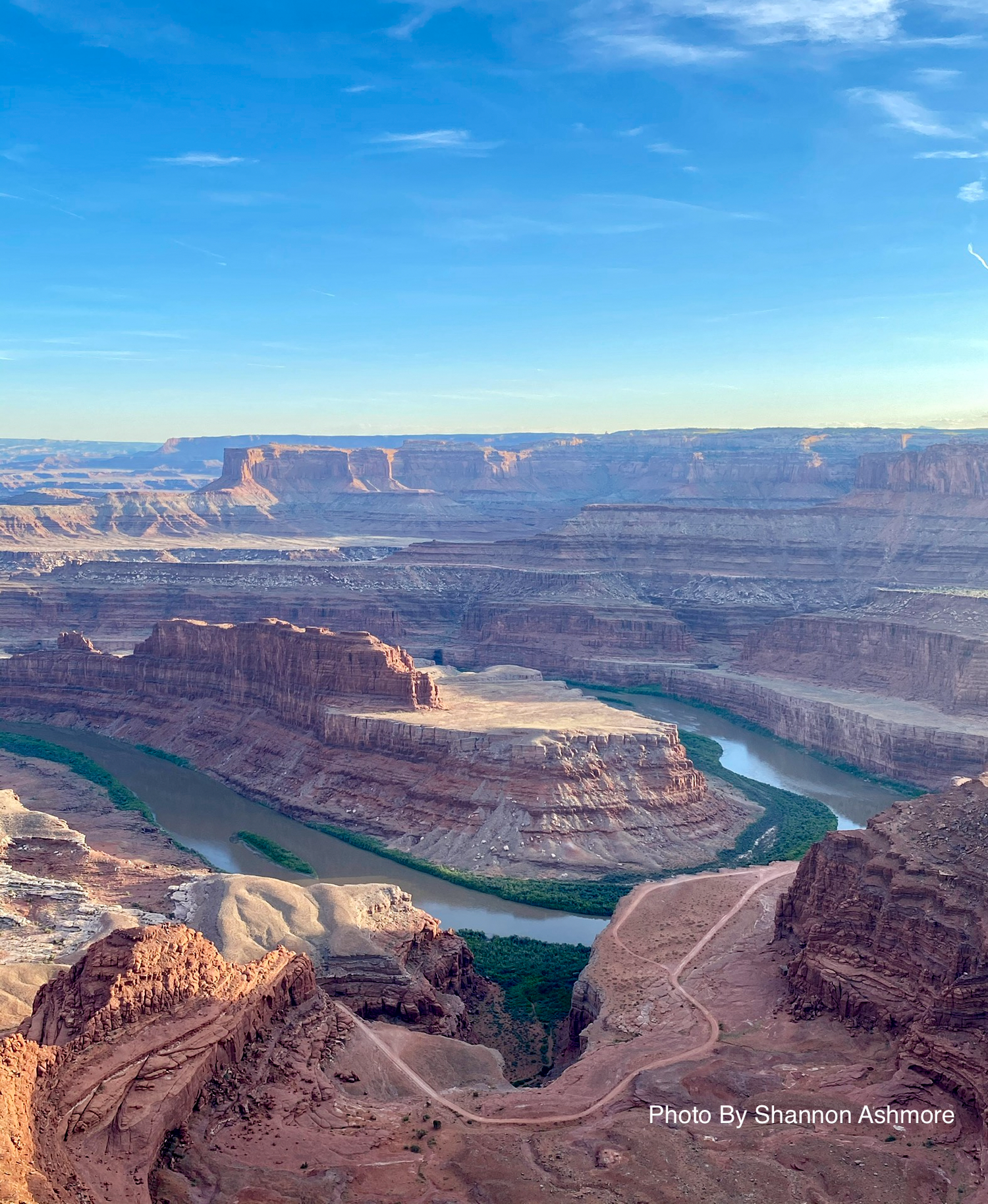 Aerial view of the Colorado River winding through Dead Horse Point State Park canyon at sunrise.