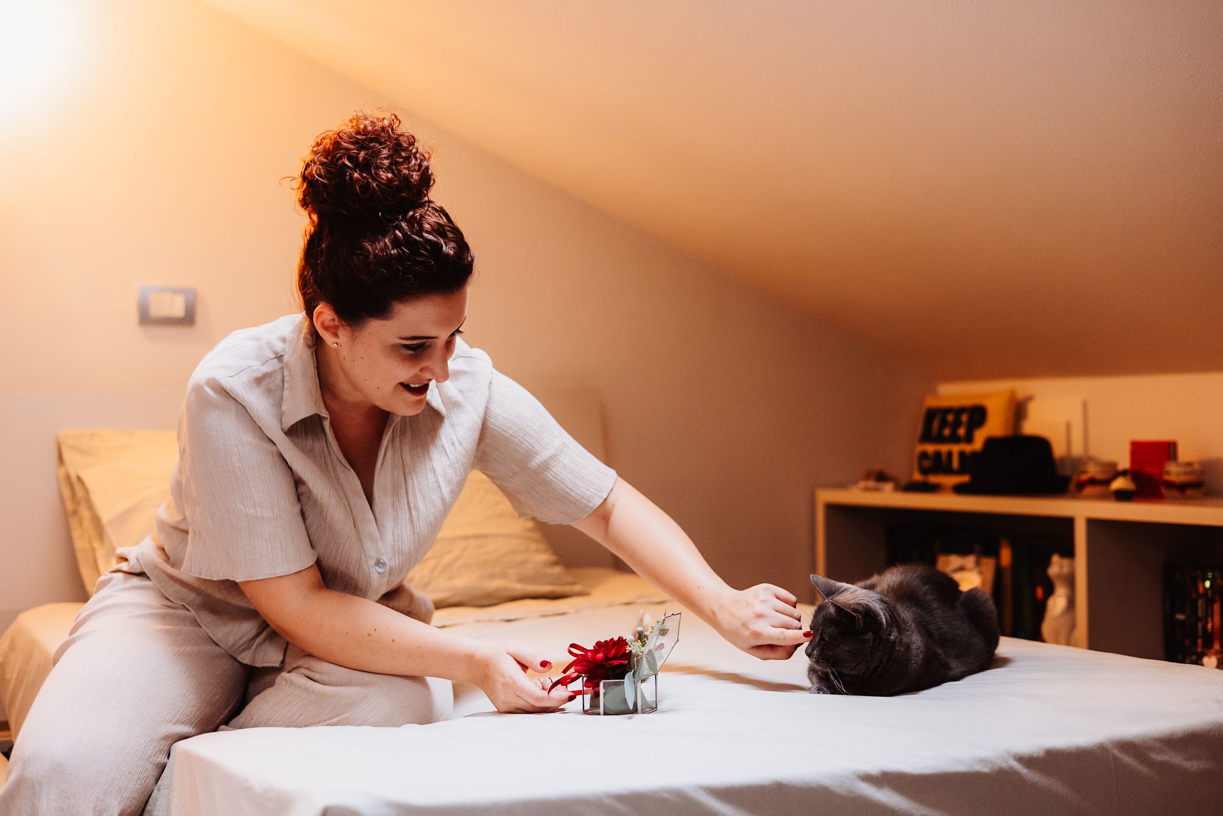 A person performs a therapeutic massage treatment on a client lying on a massage table in a warm-lit spa room.