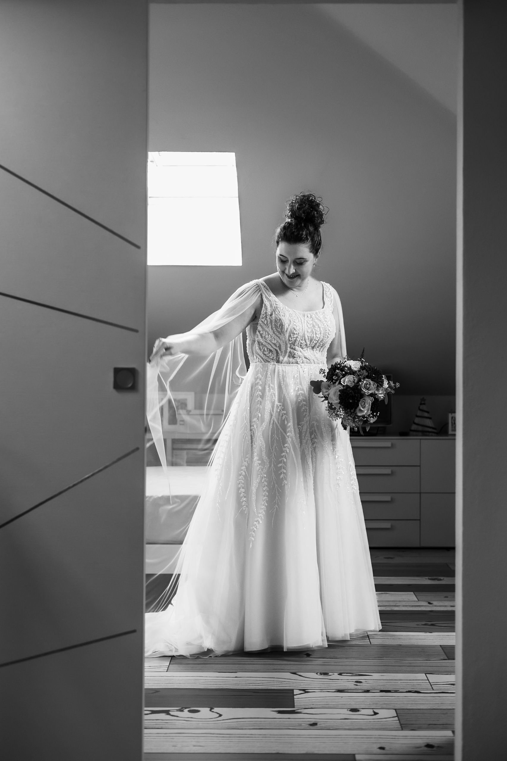A black and white photo series showing a flowing white wedding dress displayed in different angles on a staircase.