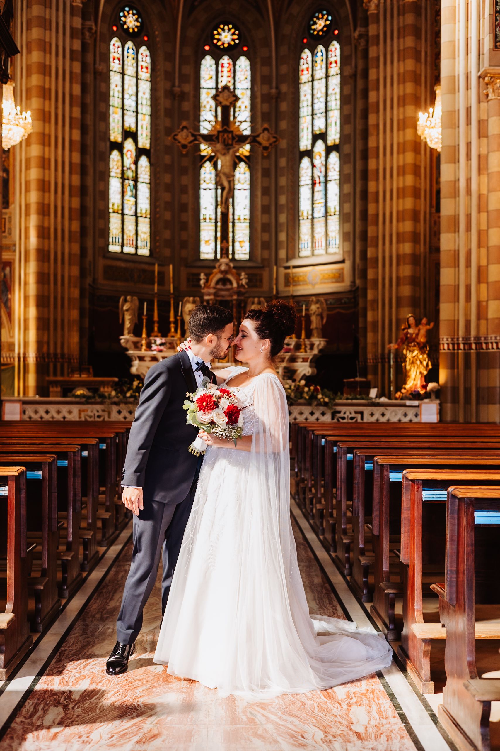 A romantic wedding scene unfolds in a grand cathedral with stained glass windows and ornate gothic architecture.