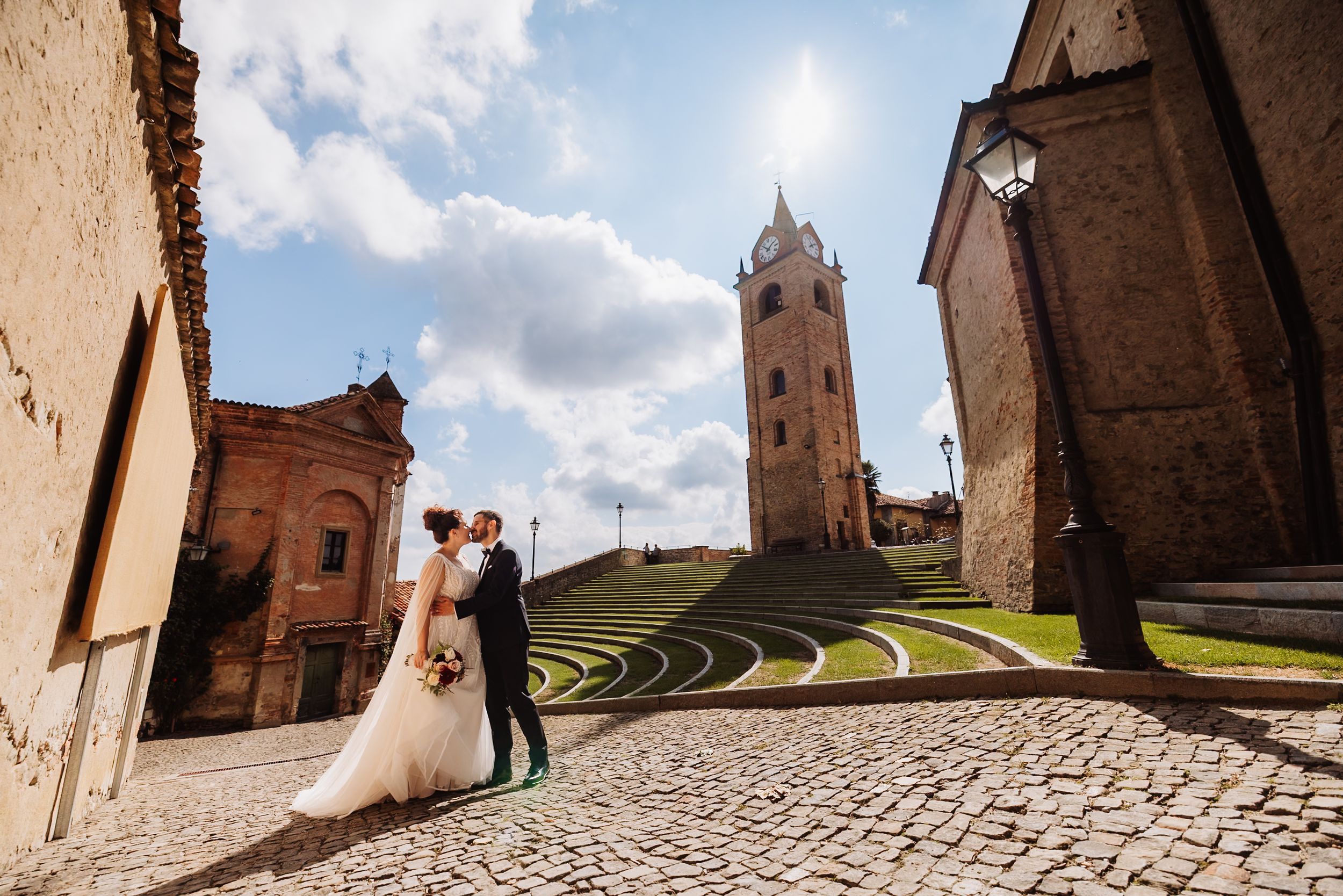 Ancient stone church architecture with dramatic cloudy sky and winding cobblestone paths in rustic setting.