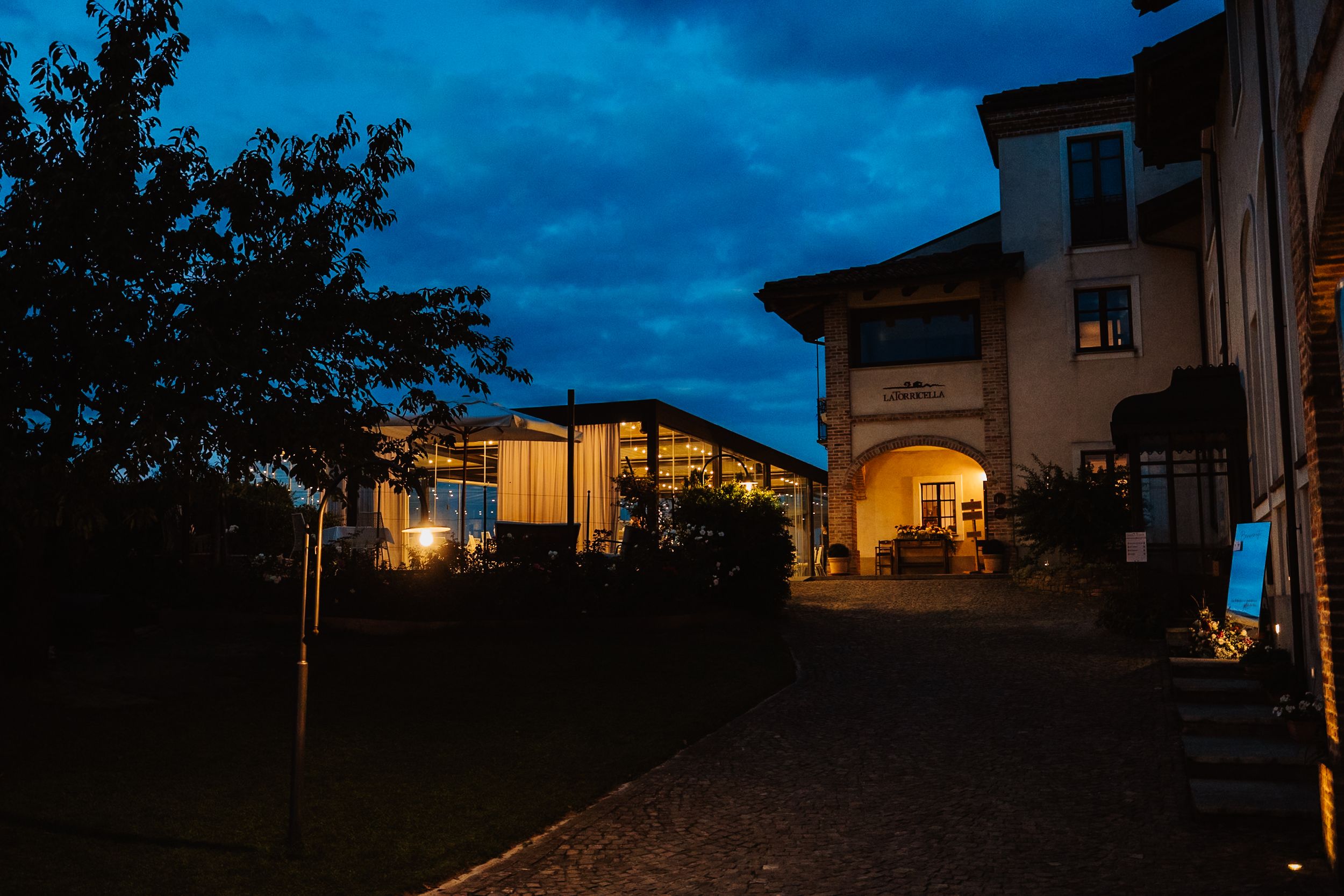 A series of twilight photos showing a suburban neighborhood with houses silhouetted against a deep blue evening sky.
