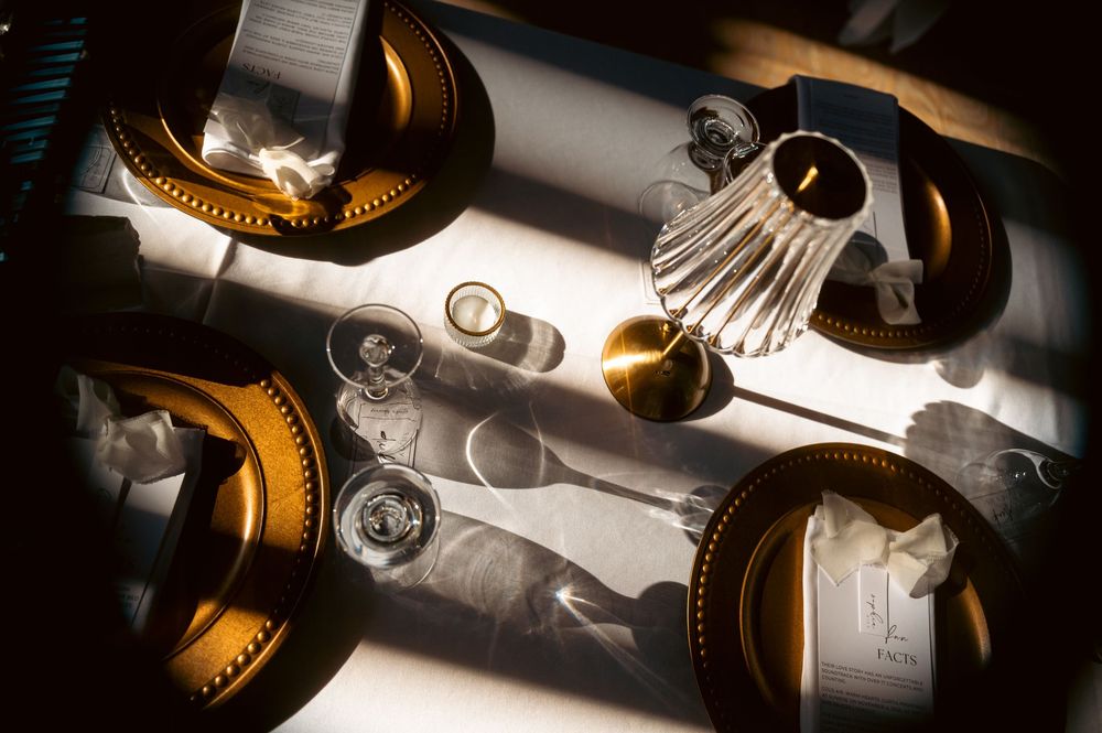 Elegant wine glasses and table settings illuminated by soft natural light.