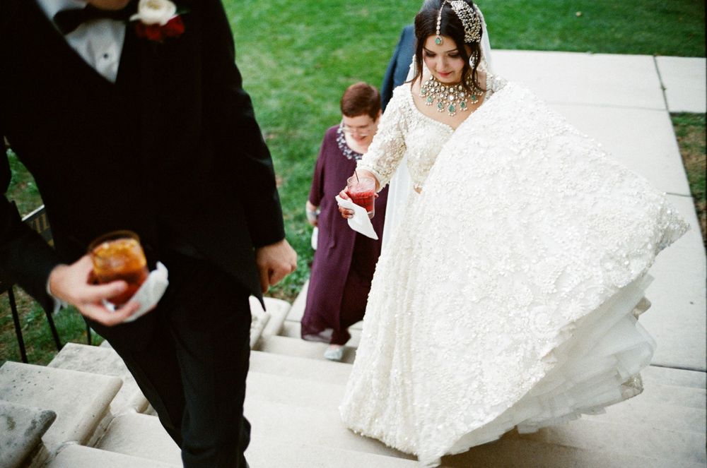 A film photo where a bride and groom enter the cocktail hour at Cuneo Mansion.