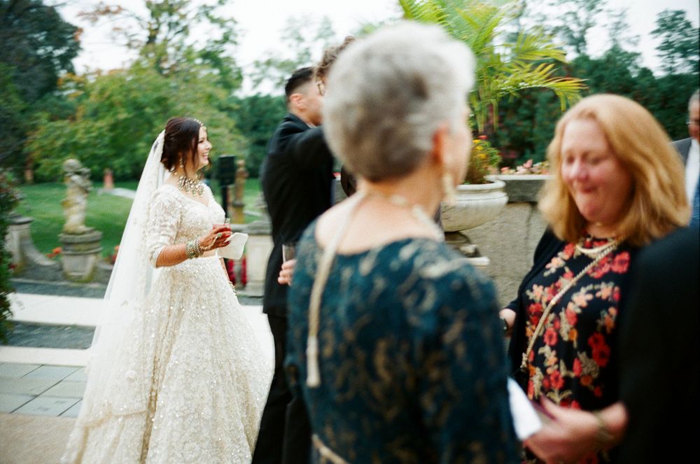 A film photo where a bride and groom enter the cocktail hour at Cuneo Mansion.