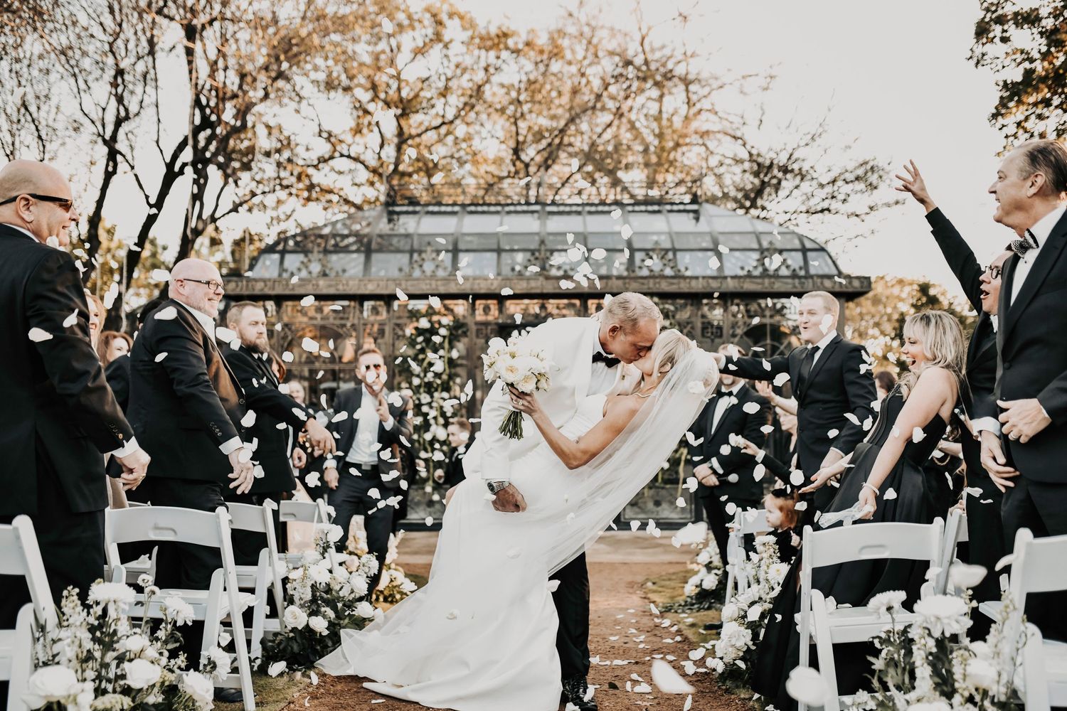 Groom dipping the bride for a romantic wedding kiss during the ceremony