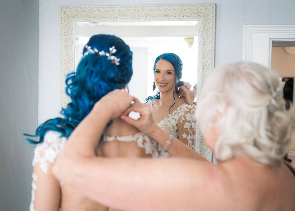A series of wedding preparation photos showing a bride getting ready in front of a mirror.