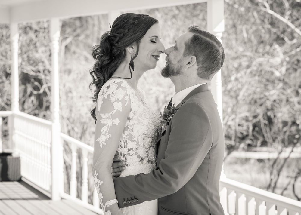 Black and white romantic wedding couple portraits on an outdoor porch.