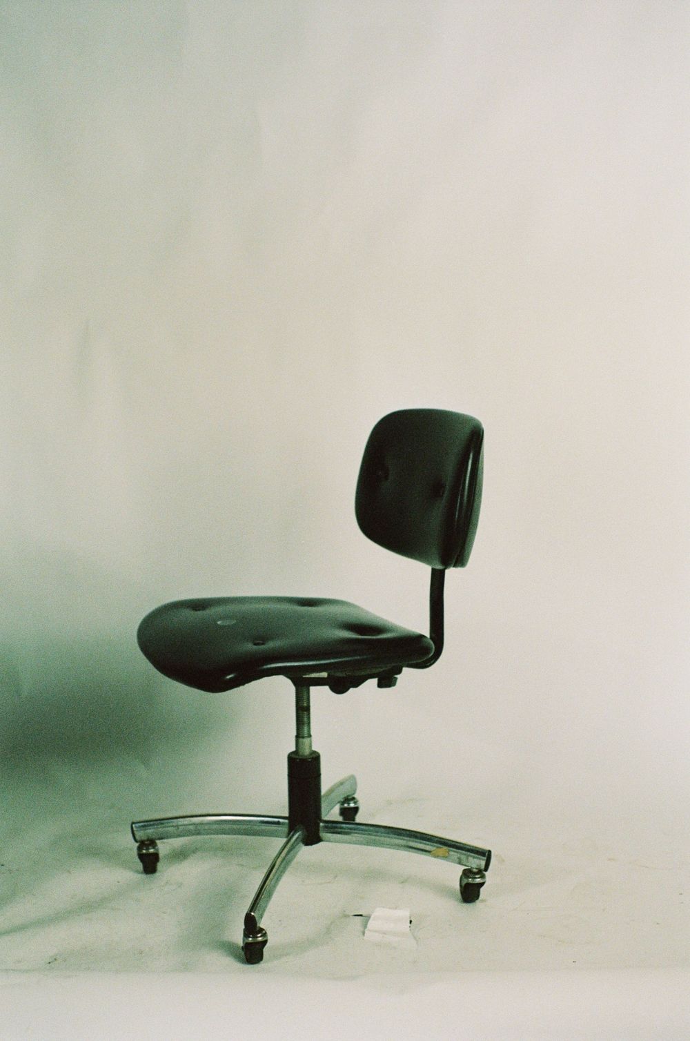 A sequence showing a black office chair at different angles against a plain background.
