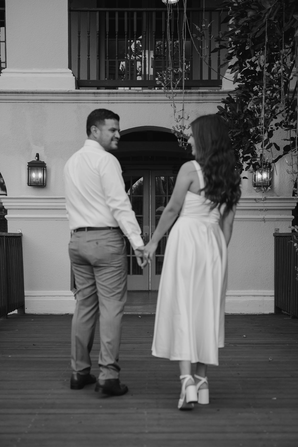 A black and white sequence showing a couple dancing together on a porch in vintage-style clothing.