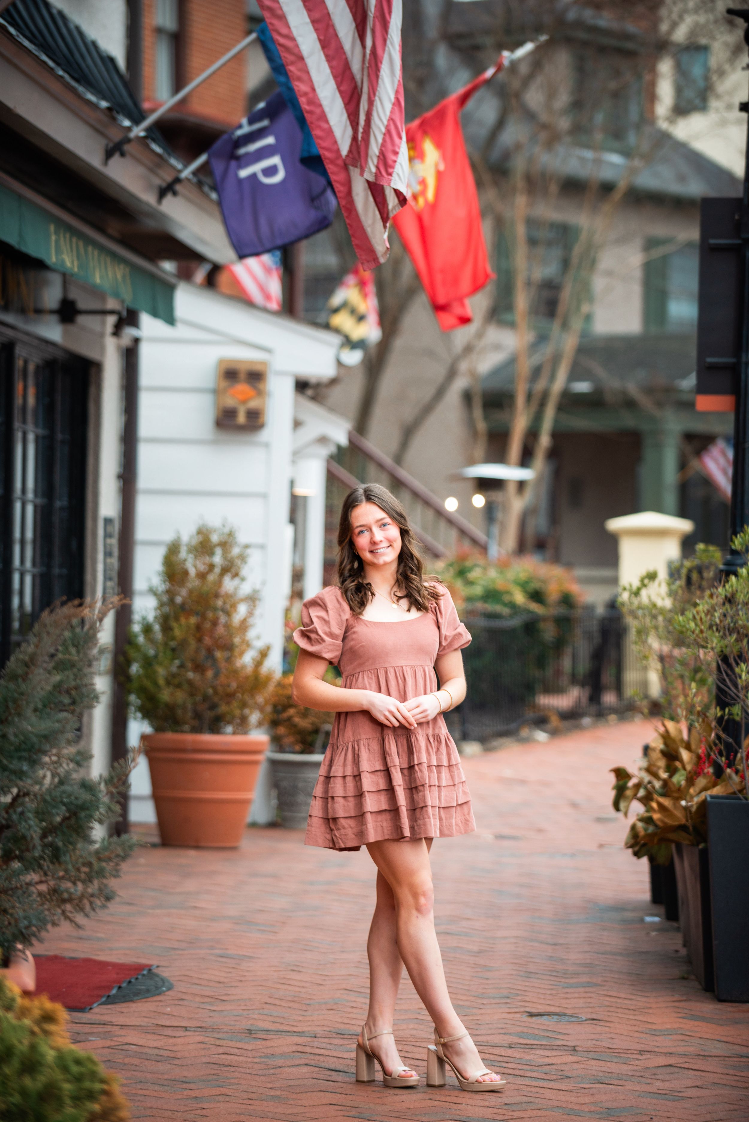 Outdoor fashion shoot on brick walkway with American flags and patriotic decor.