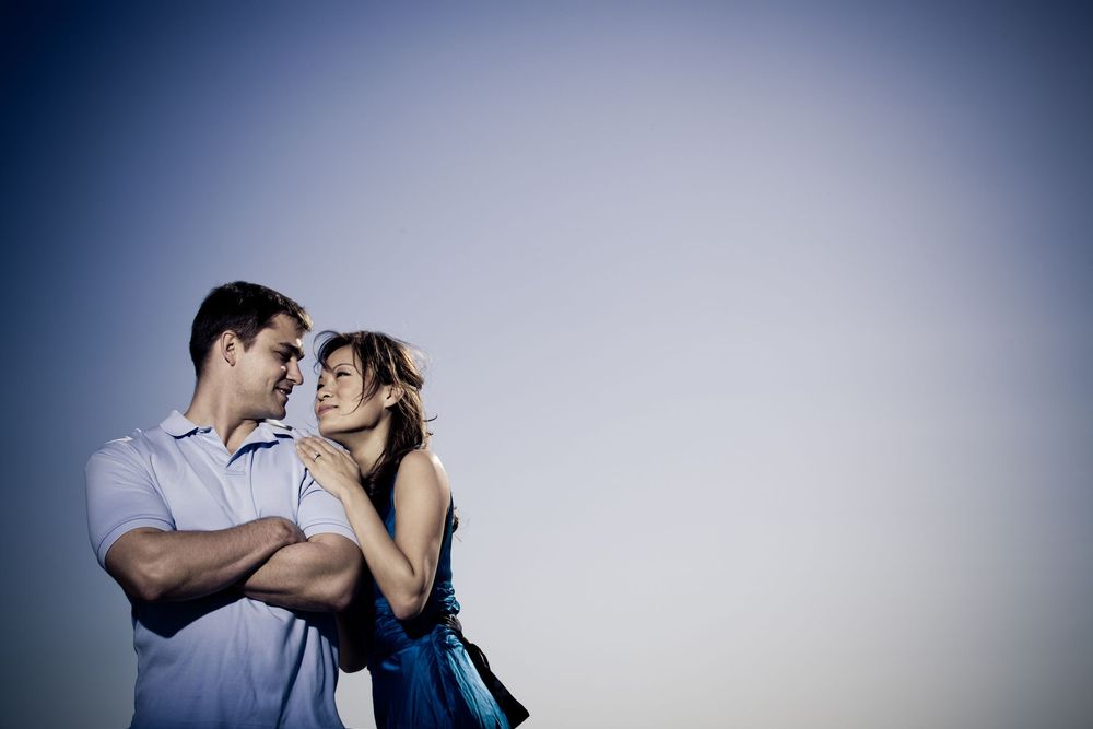 Romantic silhouettes against a blue gradient background in an artistic portrait series.