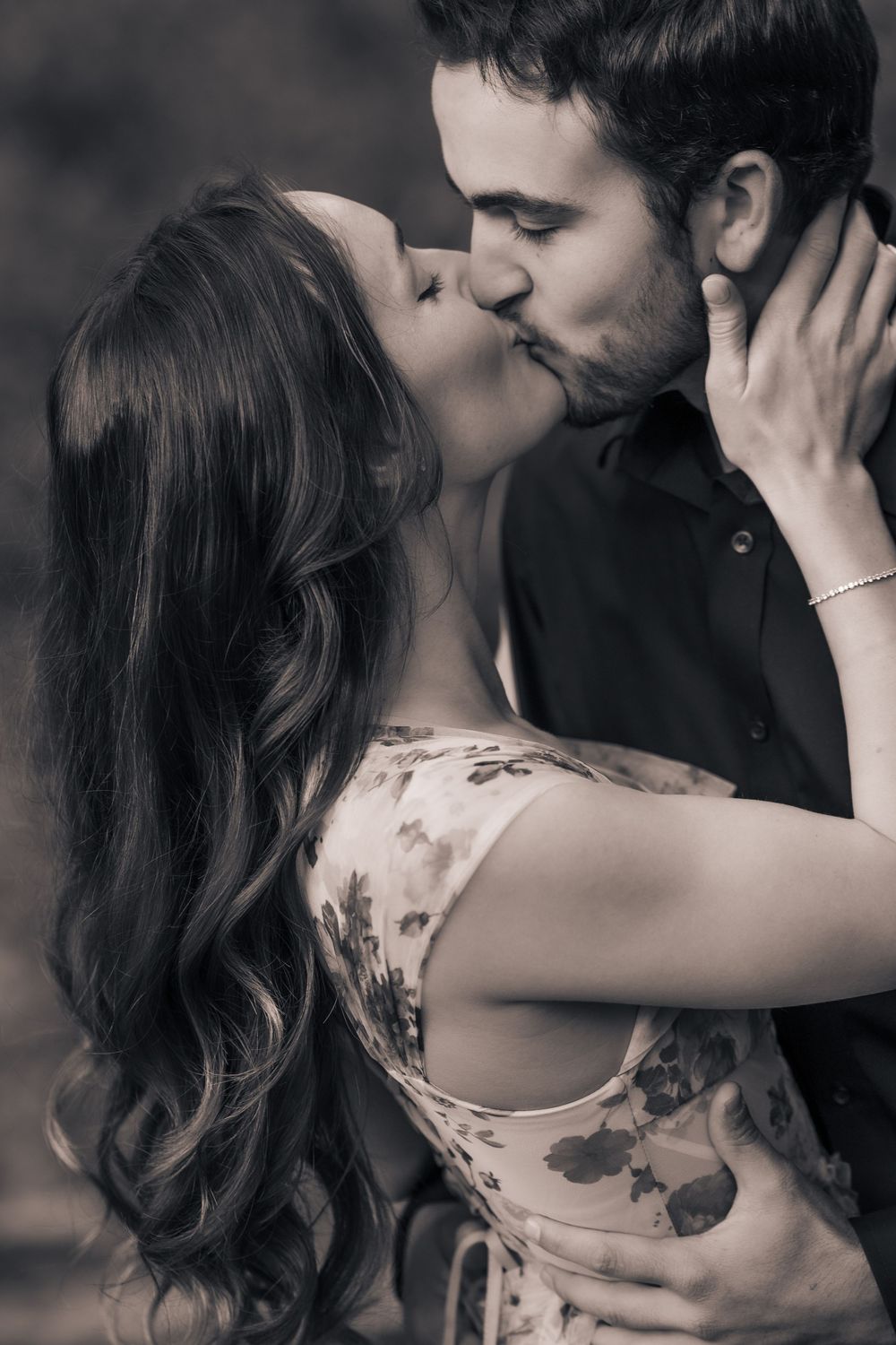 Intimate black and white portrait of couple in romantic embrace.