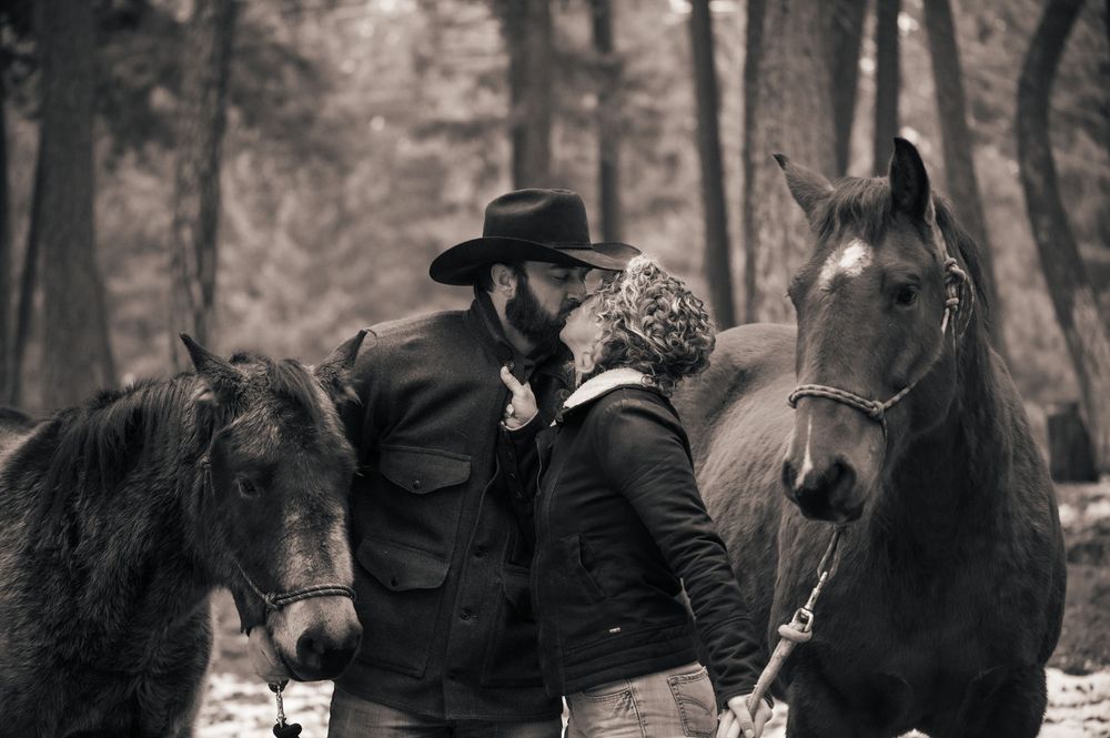 Black and white photo series of people with horses in a wooded setting.