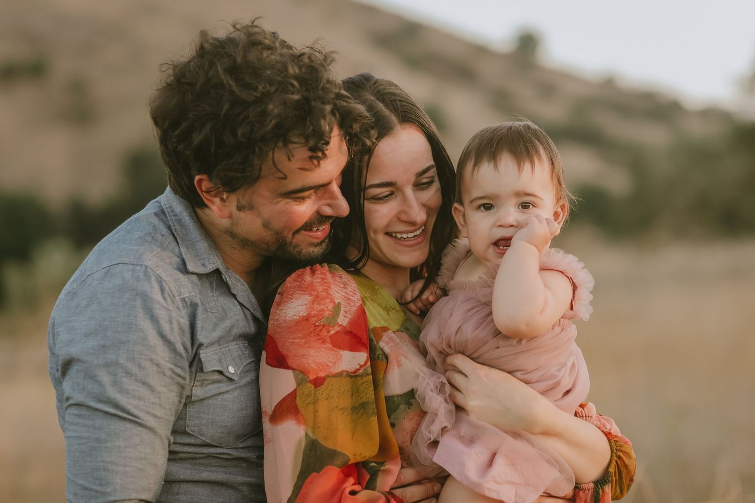 A joyful family moment captured during sunset in the outdoors.
