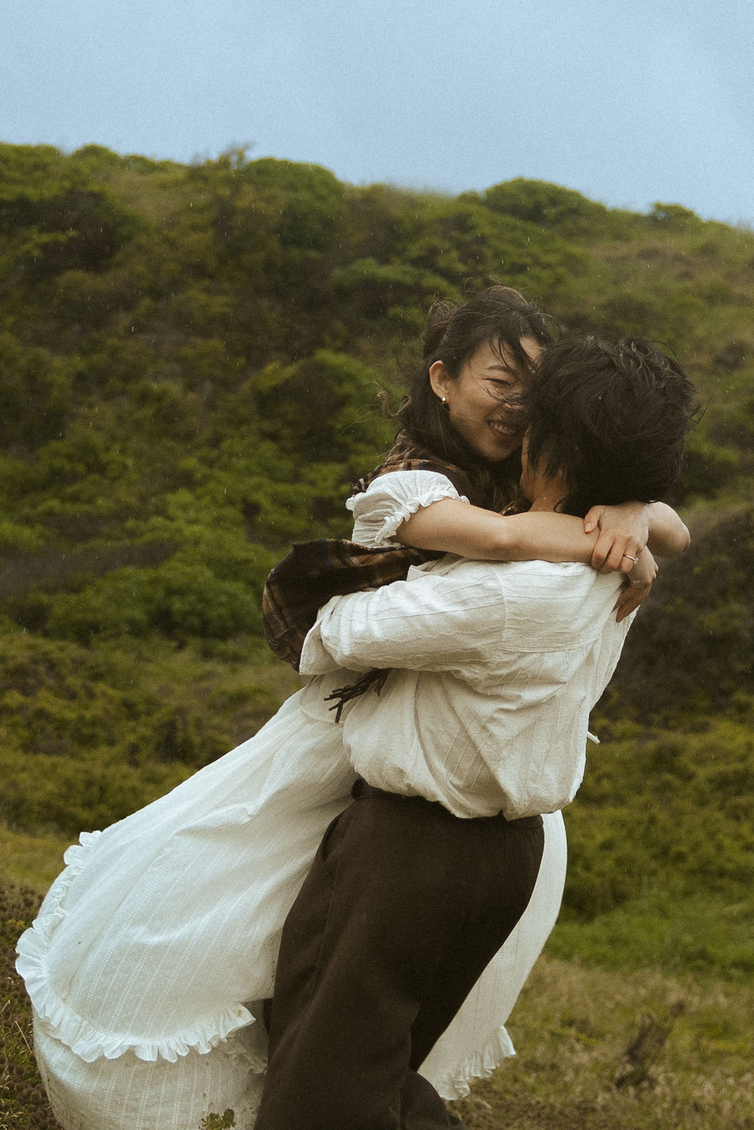 Wind-swept couple portraits on the beach during Mornington Peninsula couples session