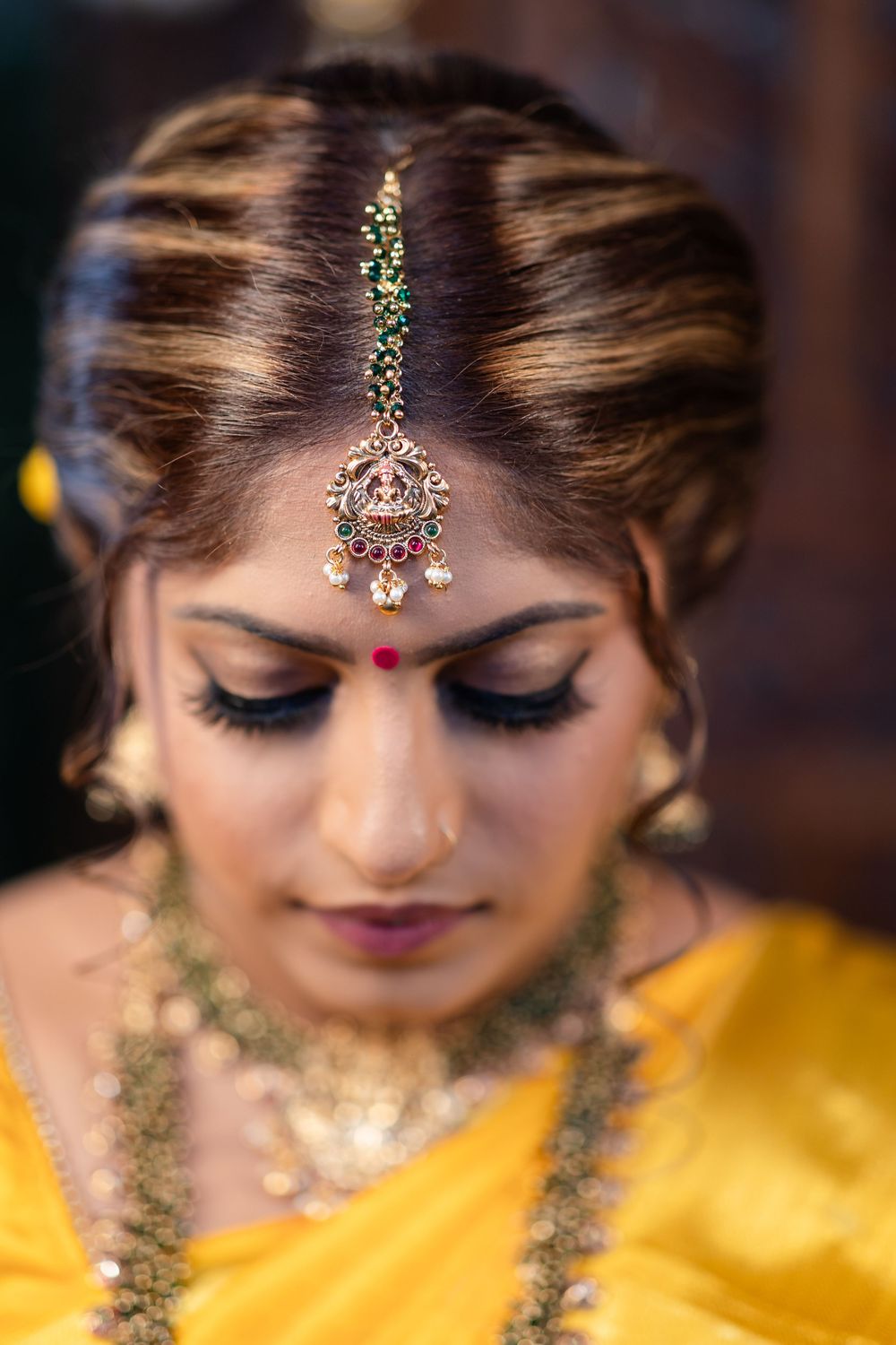 Close-up shots of traditional Indian bridal jewelry and makeup details with intricate gold designs.