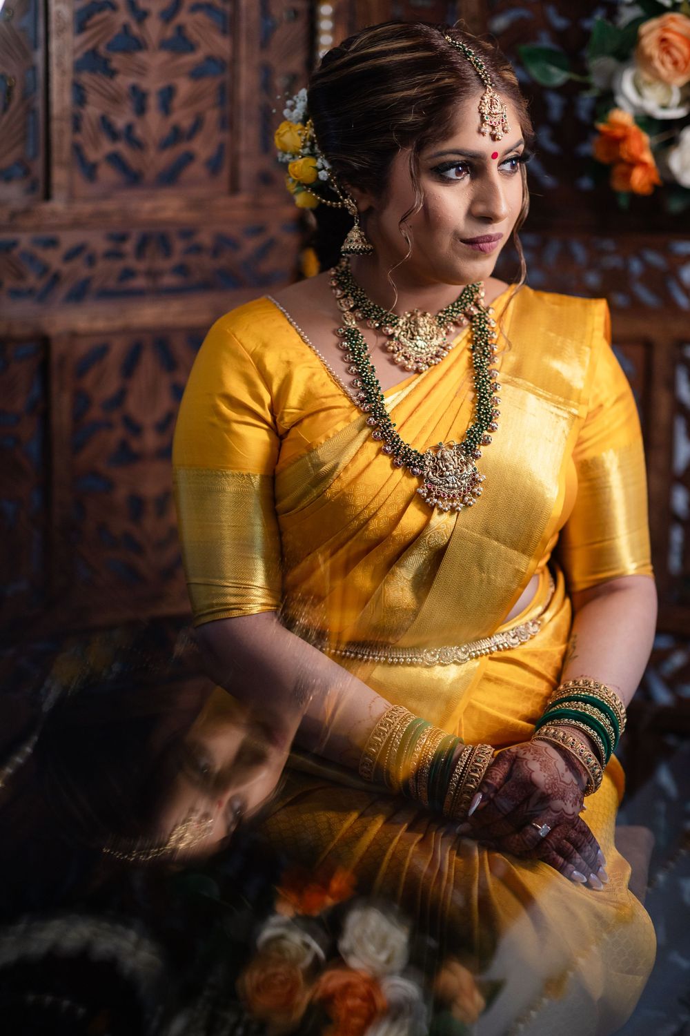 Close-up shots of traditional Indian bridal attire featuring yellow silk saree and elaborate gold jewelry.