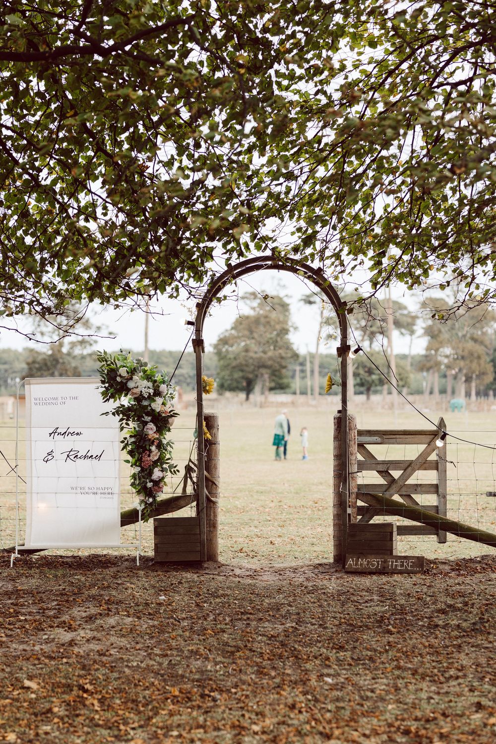A series of six connected images showing a rustic wooden gate and fence in a pastoral field setting with autumn leaves.