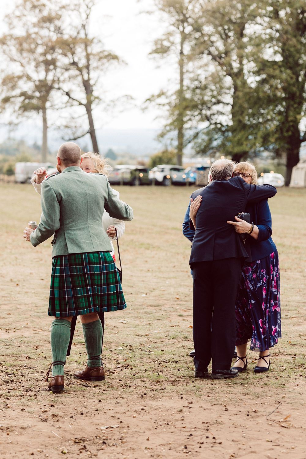 A series of photos showing a couple in traditional Scottish attire walking together on a grassy field.