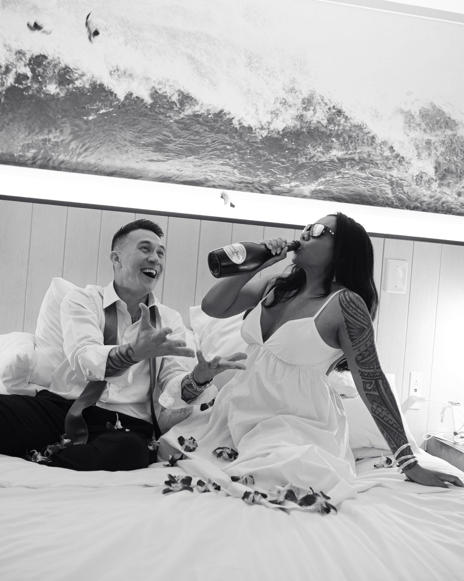 A playful sequence of black and white photos showing people laughing and having fun while lying on a bed.