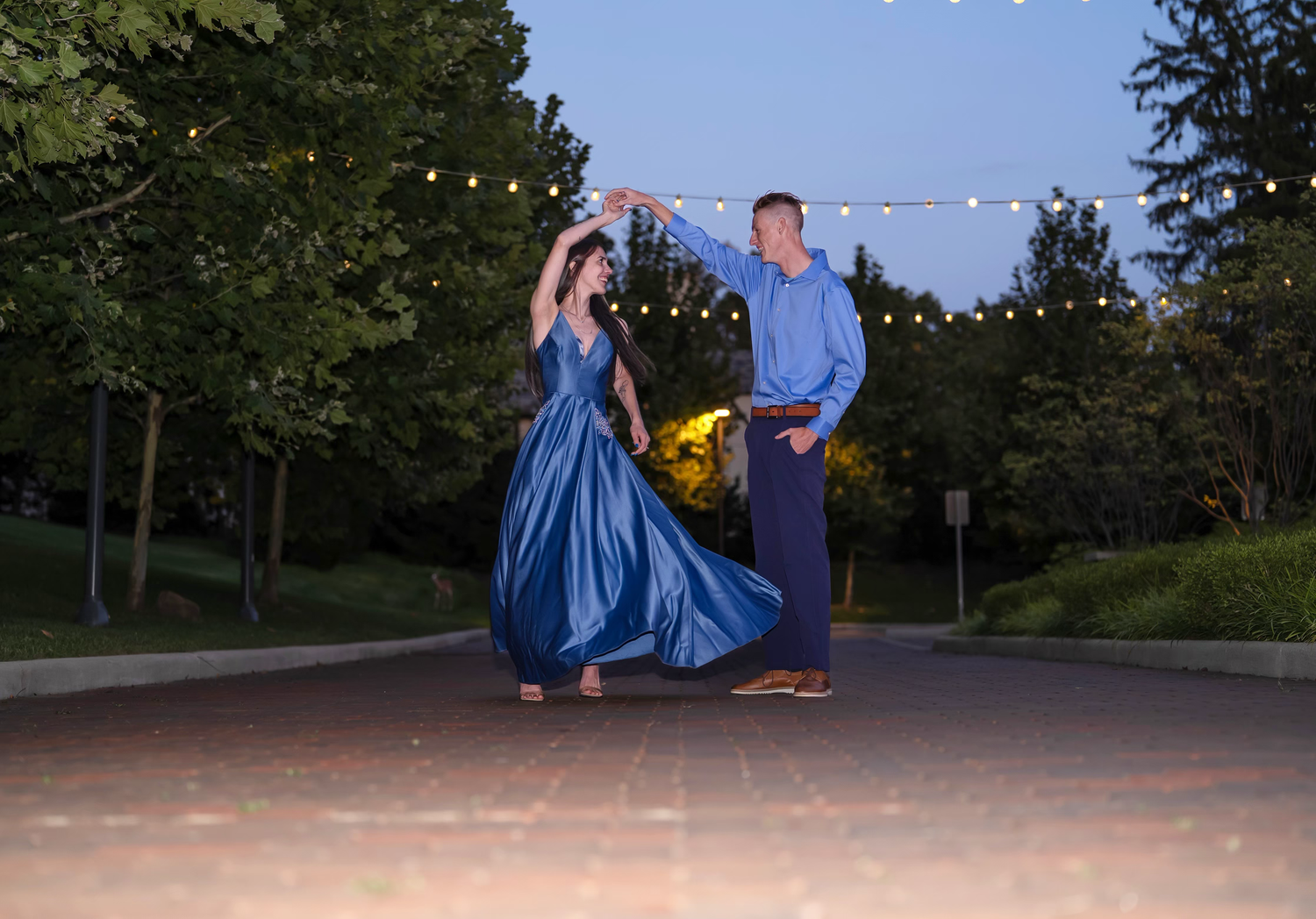 A couple in blue dances together for their engagement session