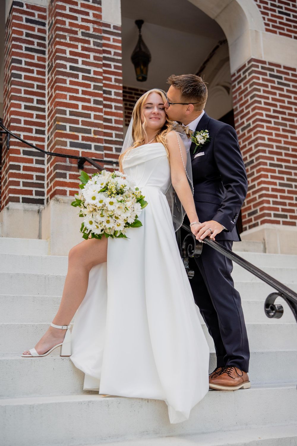 A series of romantic wedding photos showing a couple sitting on stone steps with white floral bouquets and formal attire.