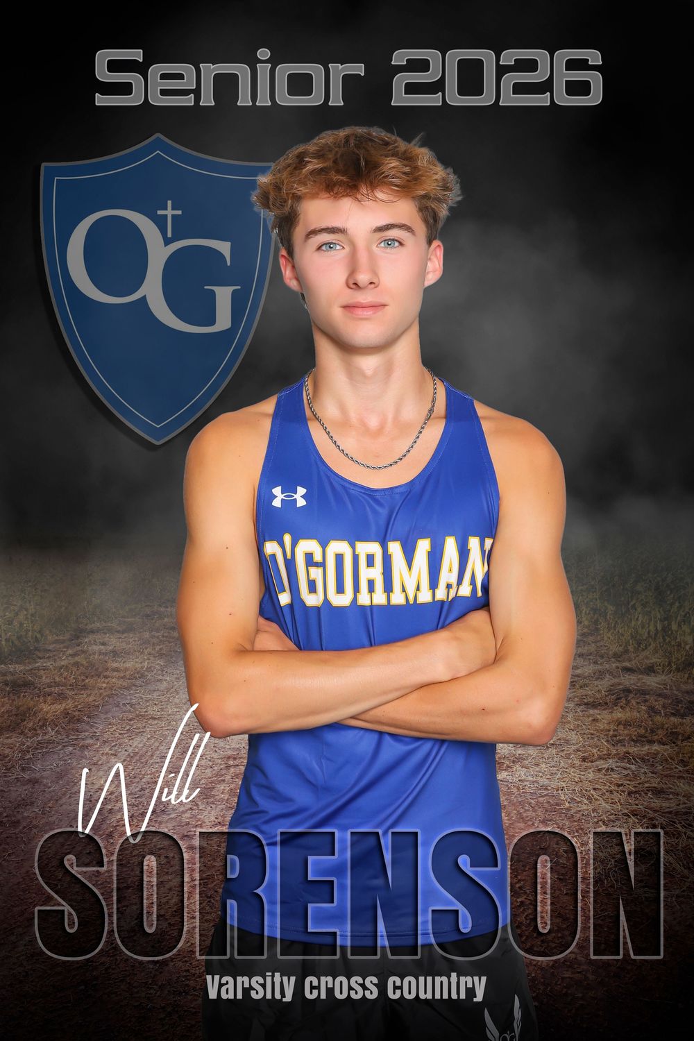 High school athlete in blue O'Gorman uniform poses for cross country senior portrait against dark background.