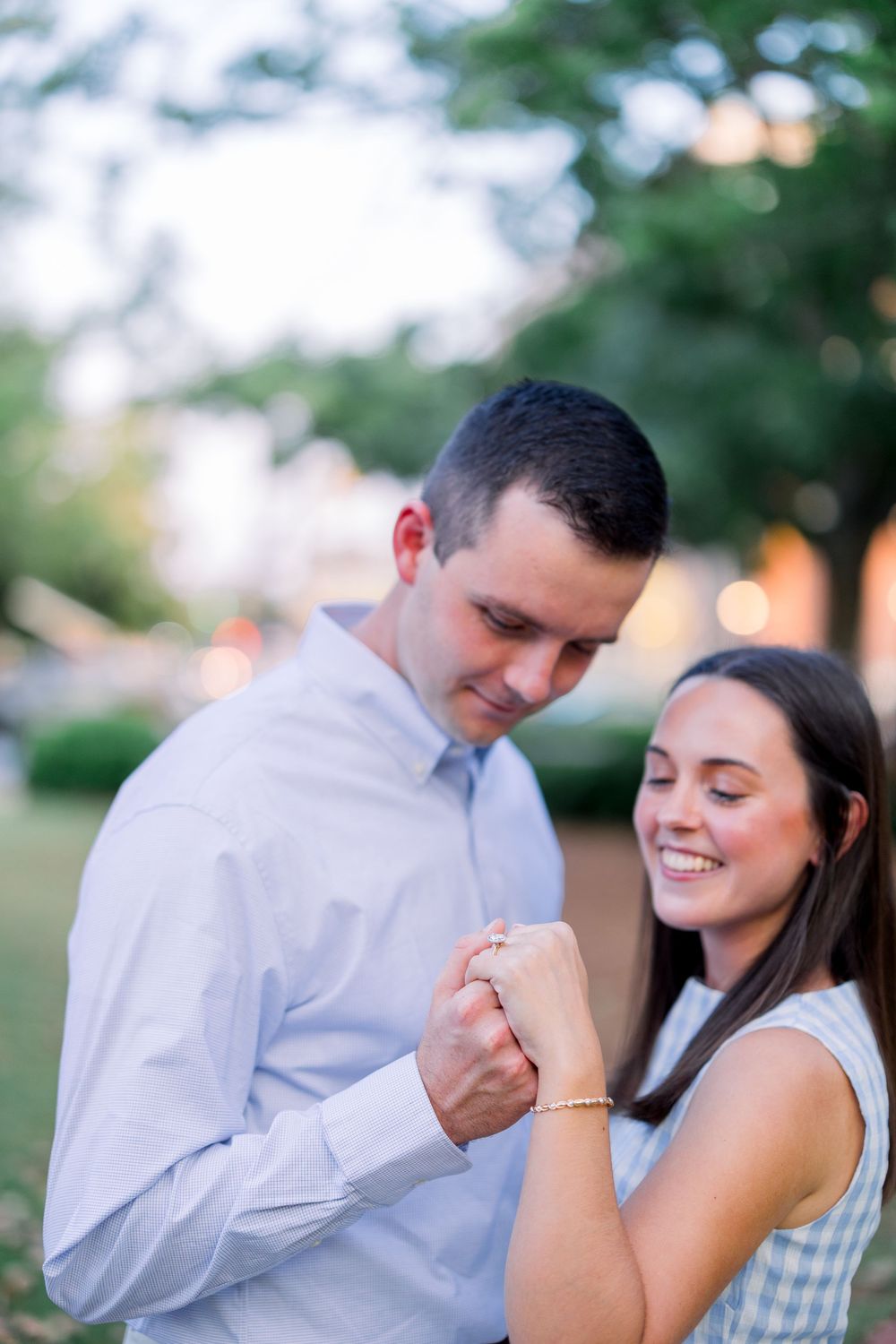 A couple shares tender moments during an outdoor engagement photo session at sunset.