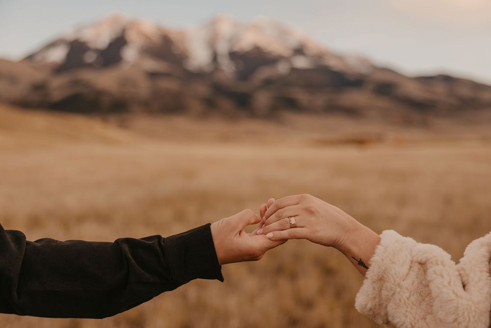 Couple shows off rings under mountains in Paradise valley for their engagement photos captured by Montana Photographer in Pray, Montana