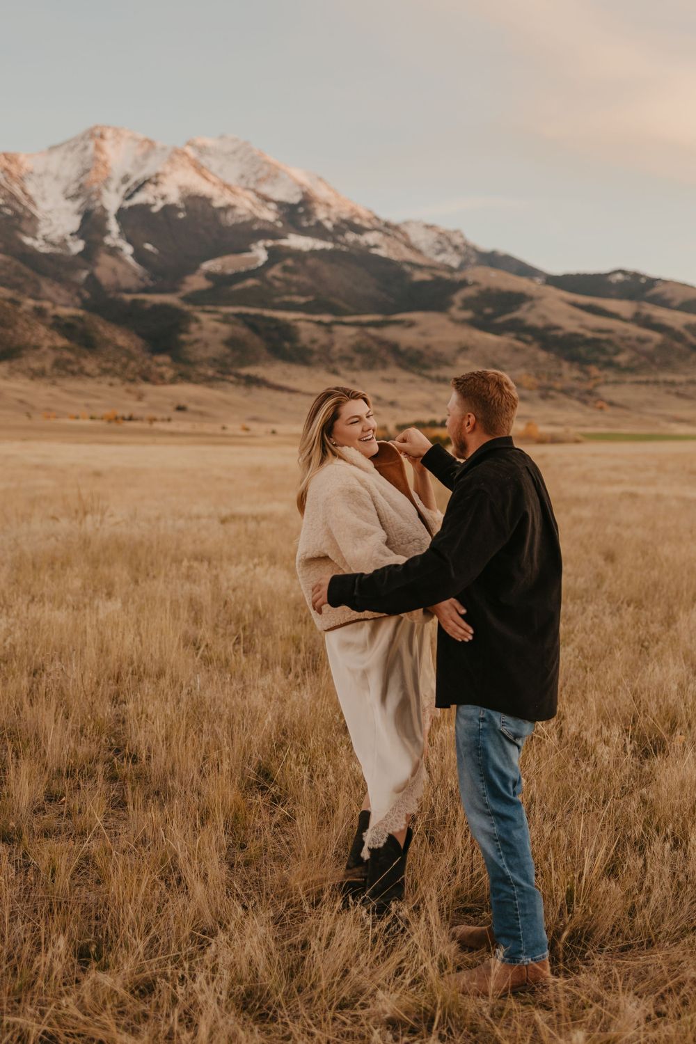 Western couple dances under the mountains in Paradise valley for their engagement photos captured by Montana Photographer in Chico, Montana