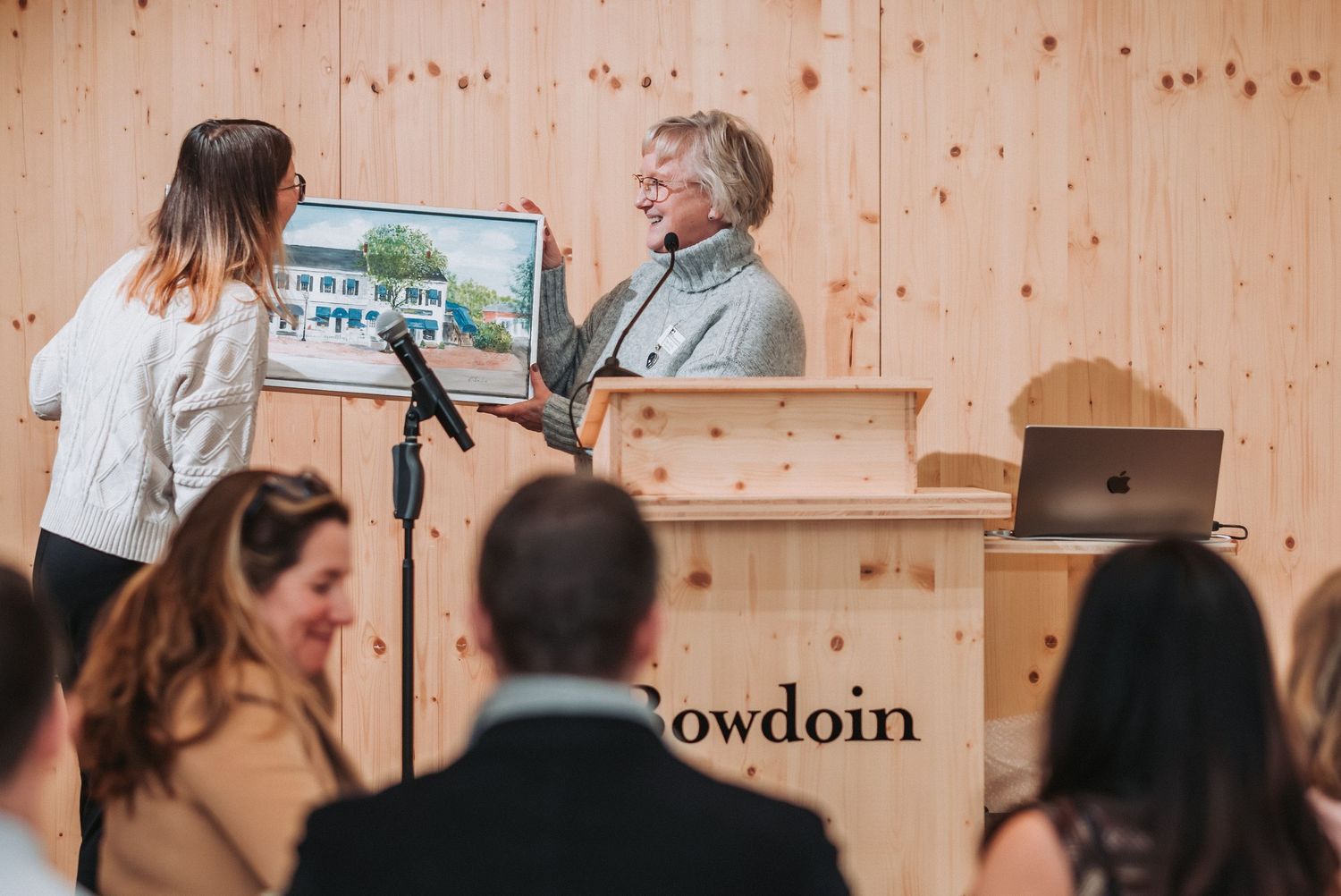An original member of the Brunswick Downtown Association is given a painting of the Downtown area to honor her time and service.