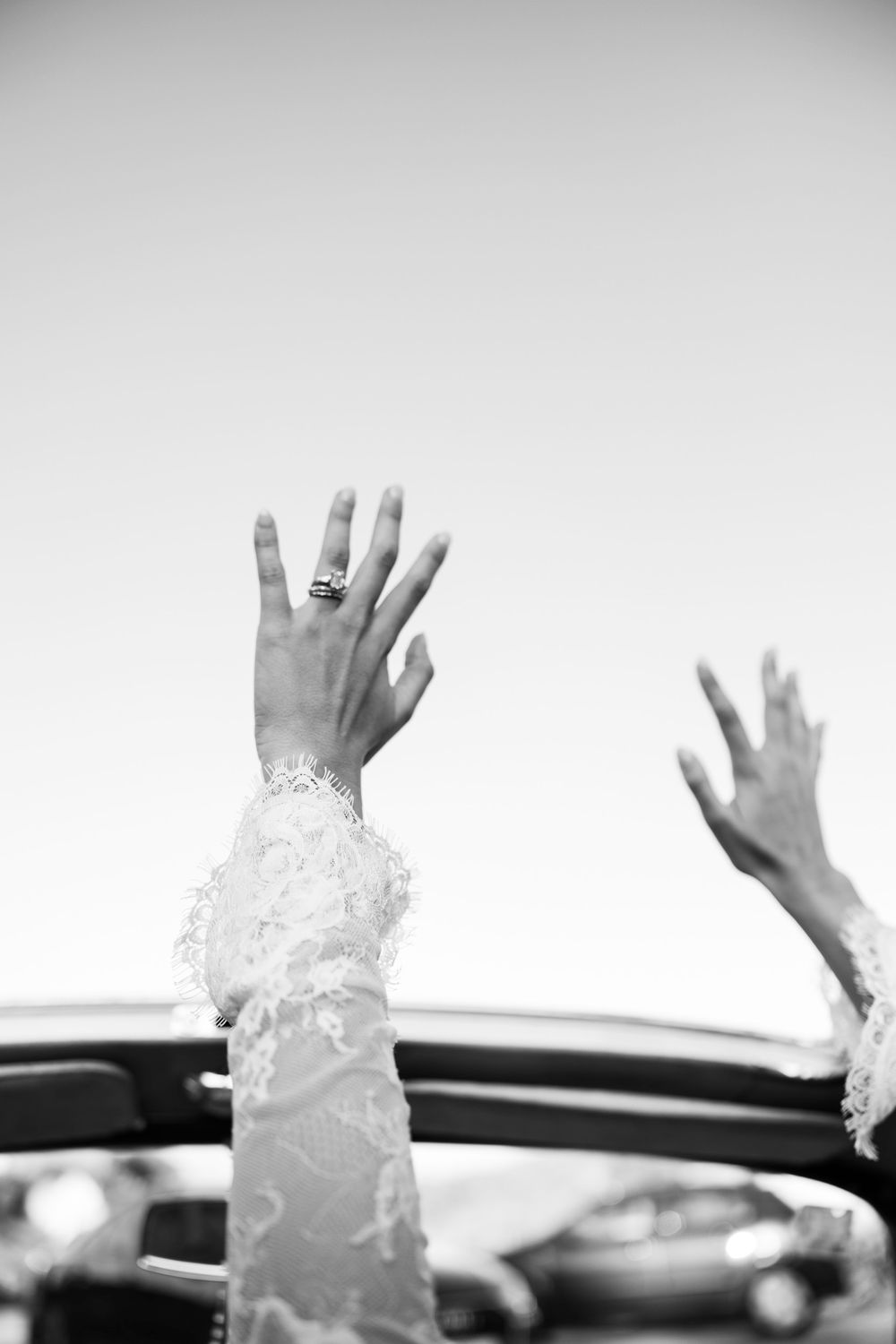 A sequence of hands reaching upward against a light background showing progressive movement in black and white.