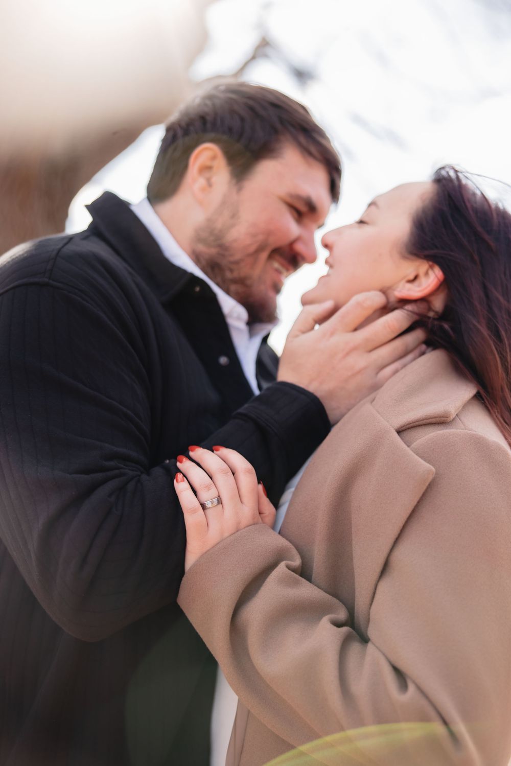 A romantic series of close-up shots showing a tender moment between a couple in winter attire.