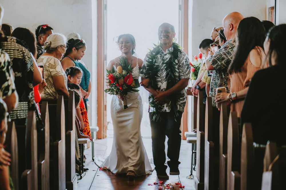 Wedding guests gather inside a bright church venue during the ceremony.