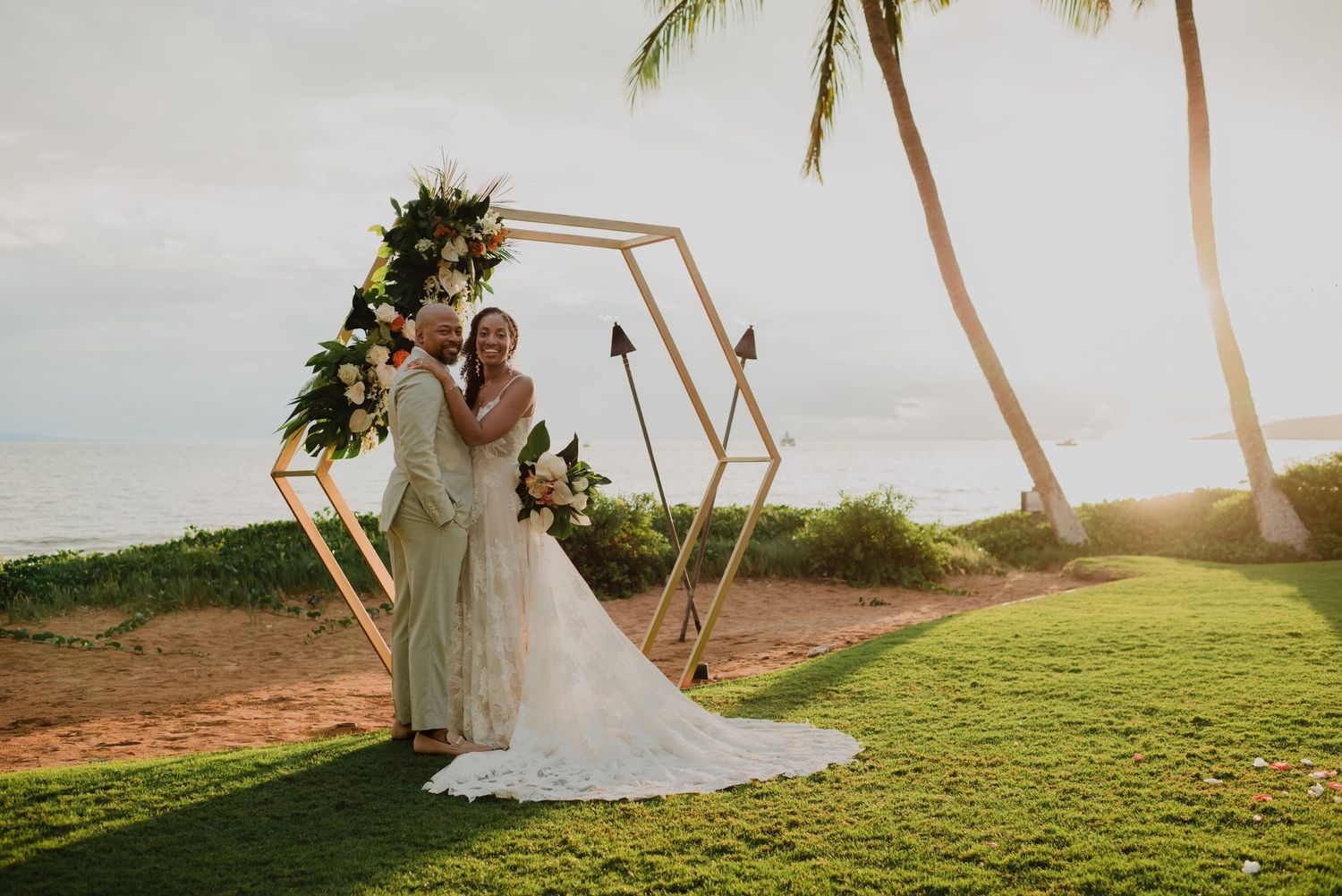 Tropical beach wedding ceremony setup with palm trees and ocean views.