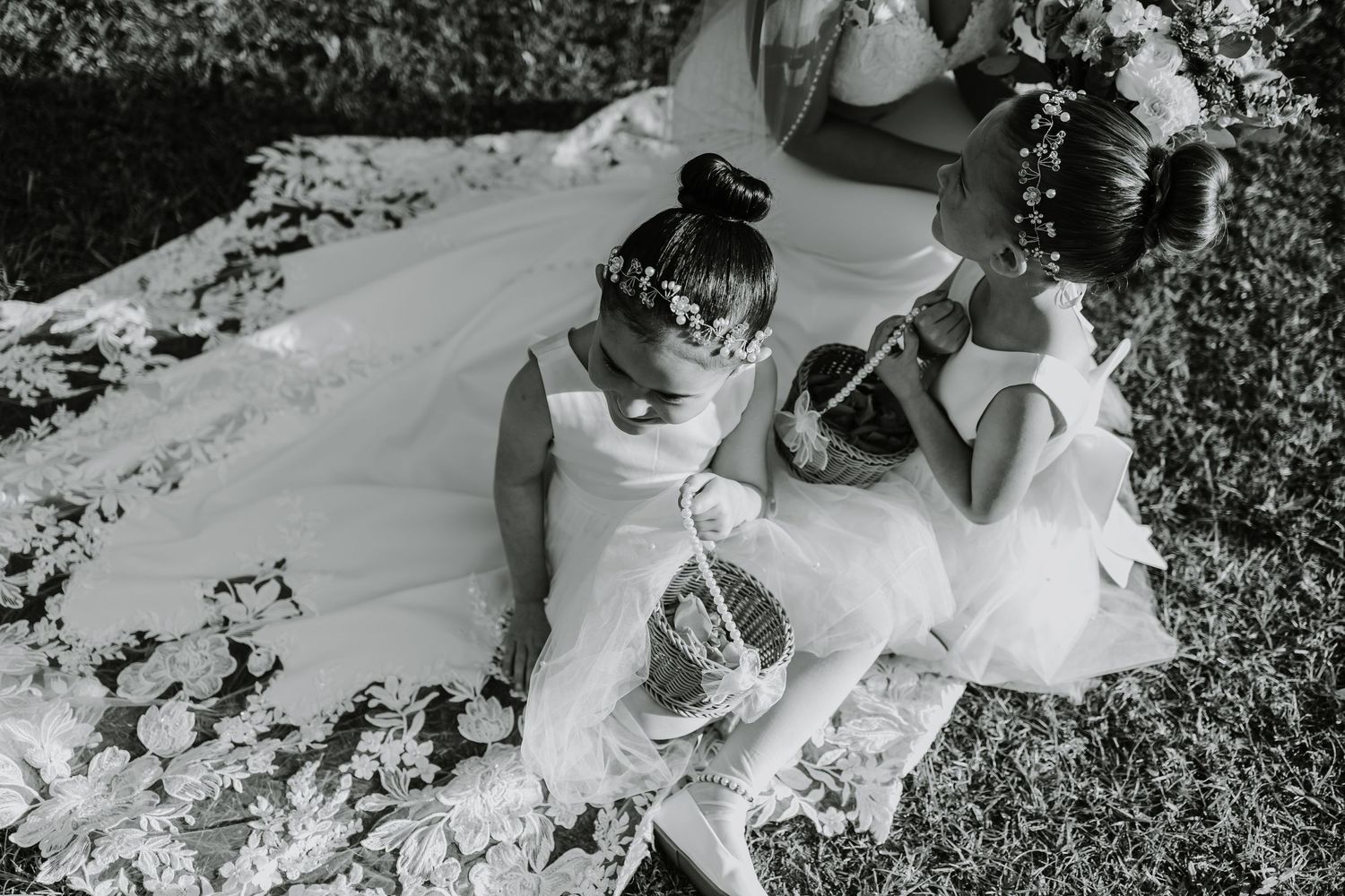 A flowing white wedding dress twirls gracefully in a sunlit autumn field with fallen leaves scattered on the ground.