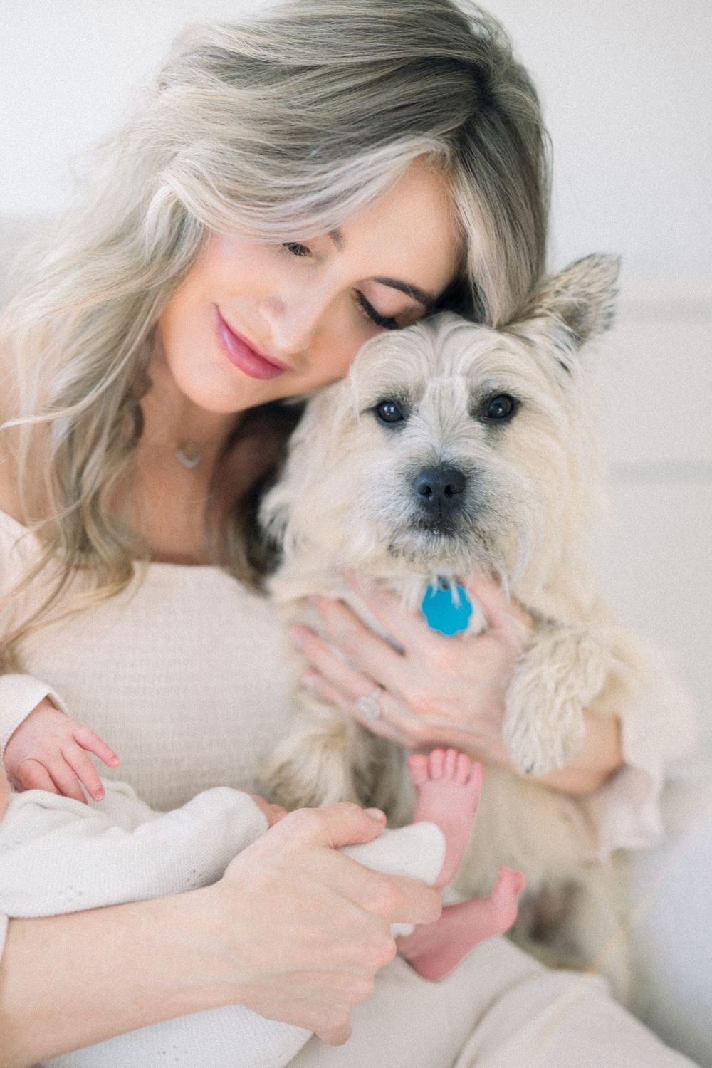 Mom holding newborn baby and dog during an in home newborn session in Washington DC