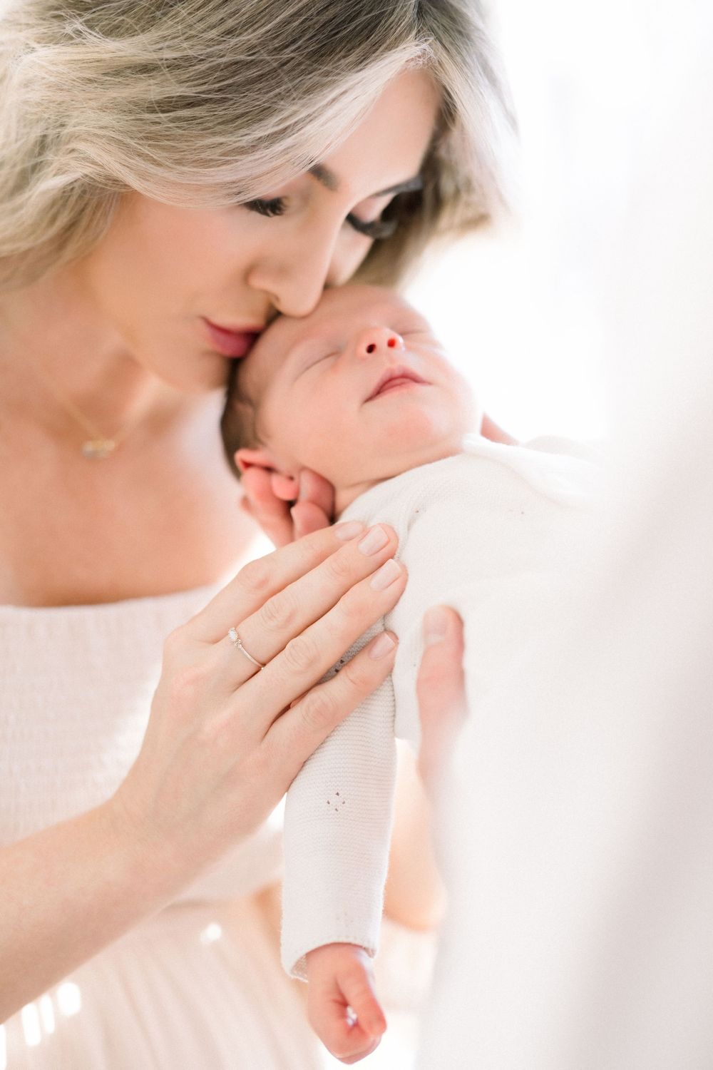 mom kissing baby taken by a dc newborn photographer