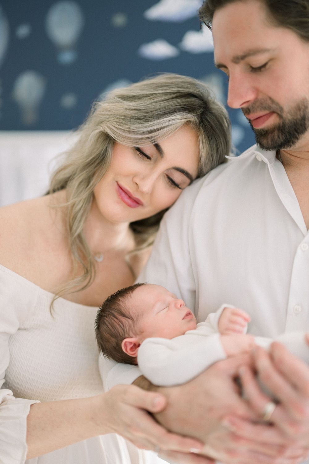 a mom and dad with newborn during an in-home newborn session in Washington DC area.