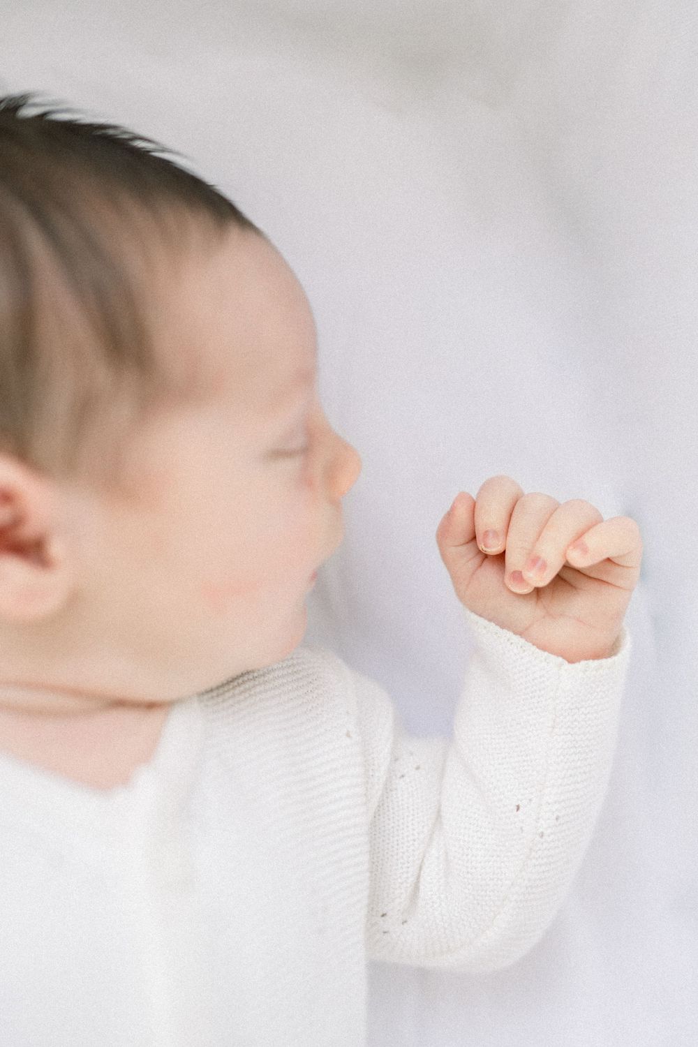 baby hand and closeup of face at an in-home newborn session in Northern Virginia