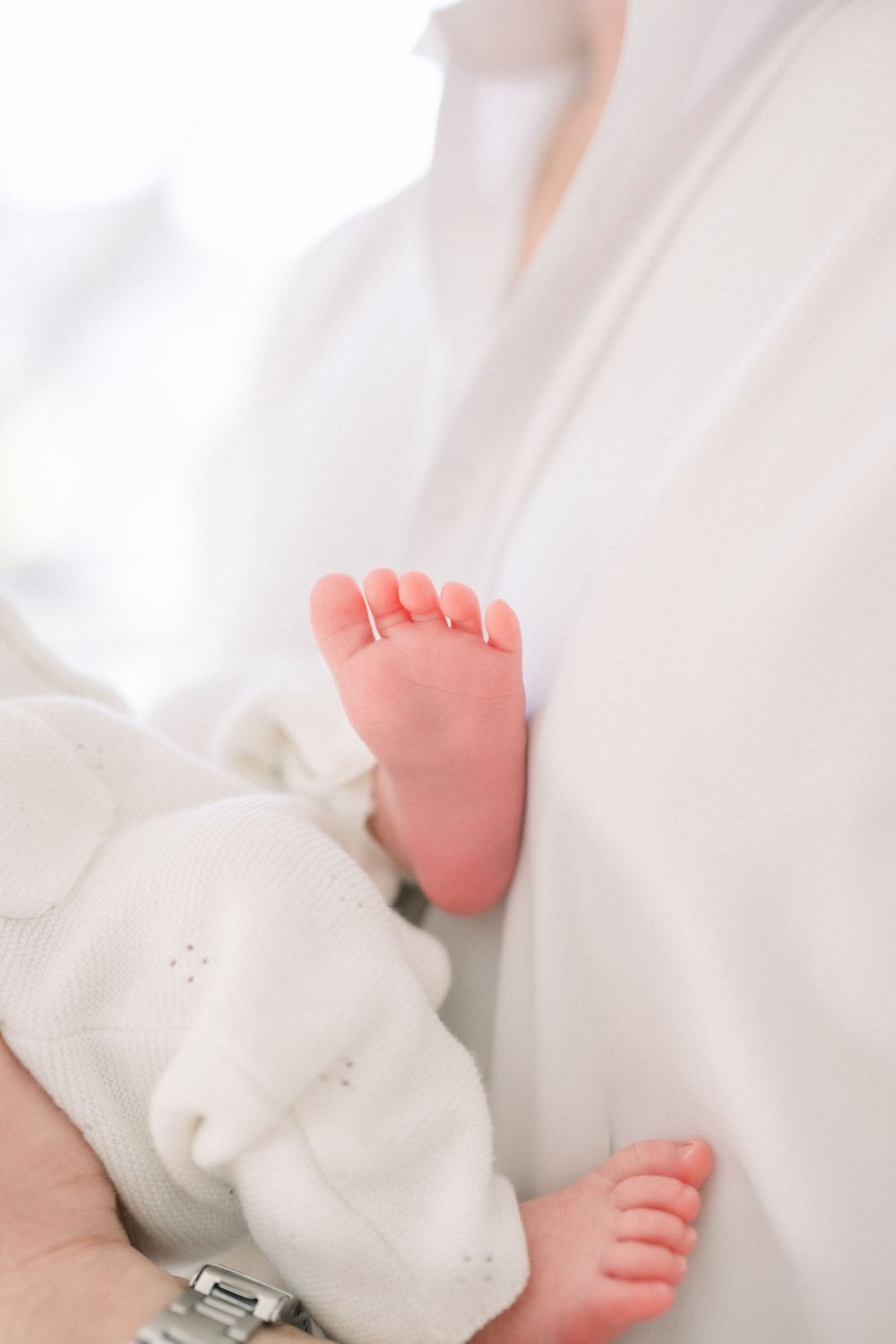 baby feet on dad's collared shirt at an in-home newborn session on Capitol Hill