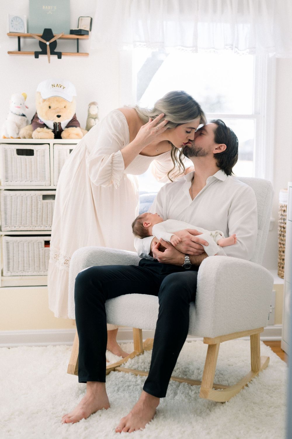 A neutral nursery and two happy parents with newborn at a lifestyle newborn session in washington dc