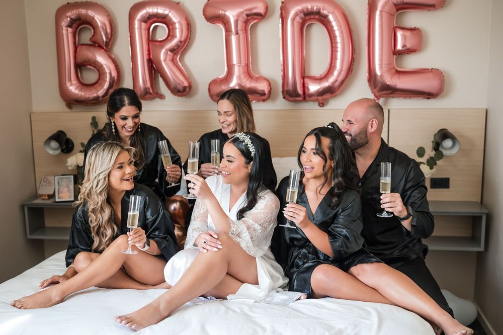 Bride and bridesmaids posing together with balloons during getting ready