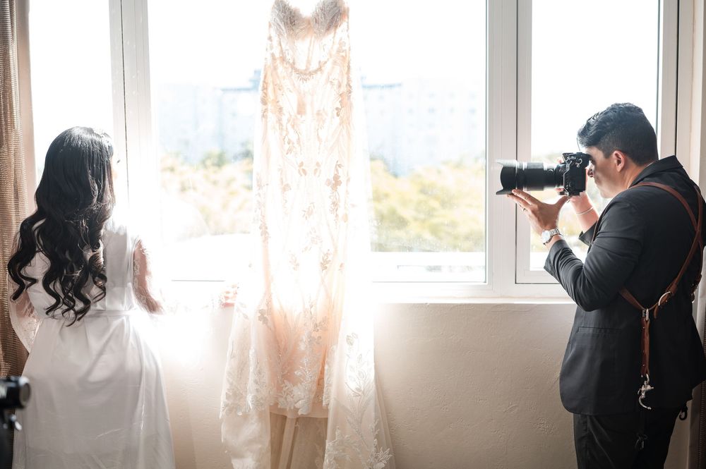 Photographer capturing wedding dress during bridal preparation