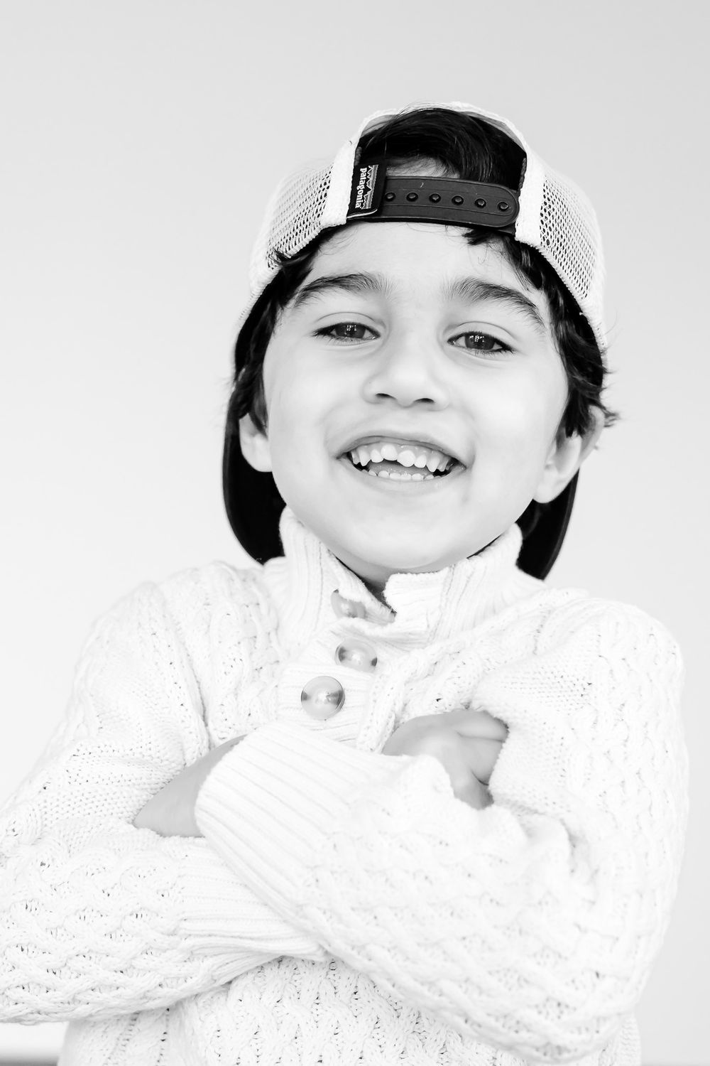 Child laughing while posing for a mini portrait at Northbrook’s I Just Am Studio