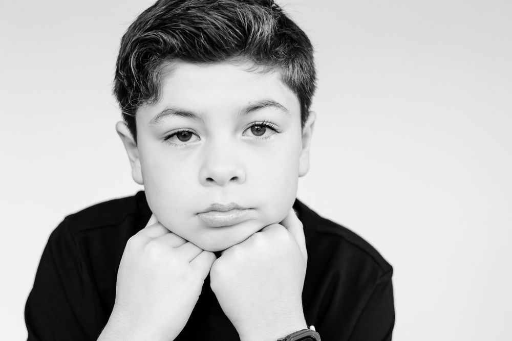 Child with thoughtful expression during a guided mini portrait session in Northbrook