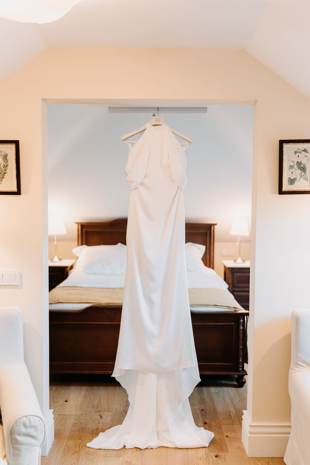A wedding dress displayed in a room with hardwood floors and white walls, shown from different angles.