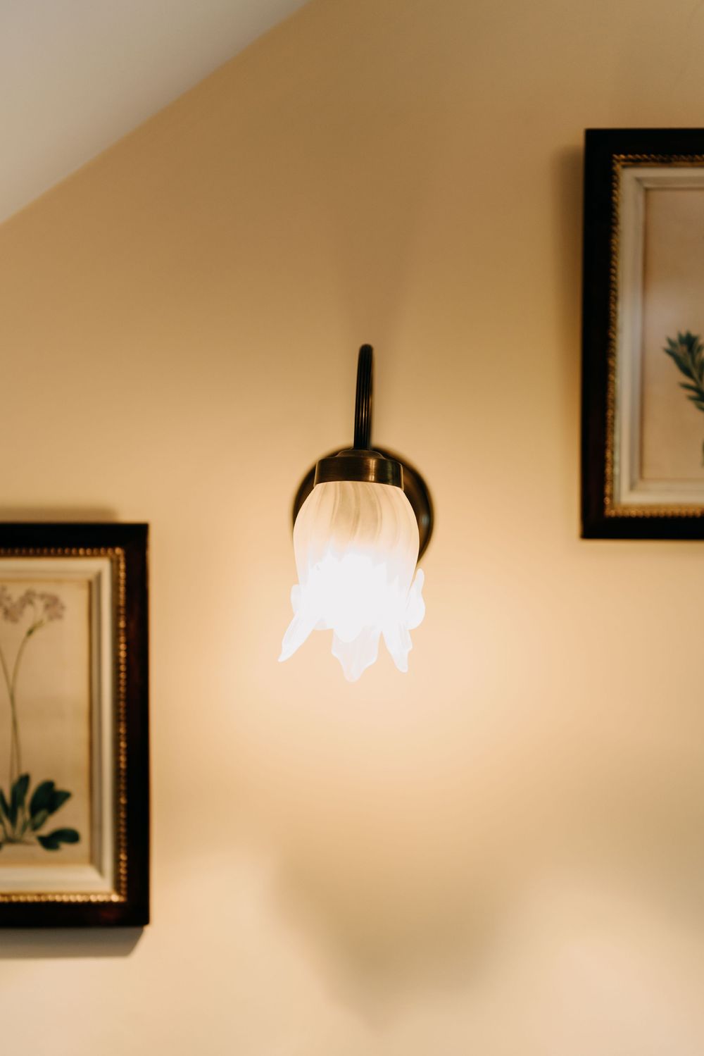 A series of blurred, warm-toned interior wall sections with framed artwork and soft lighting creating an atmospheric ambiance.
